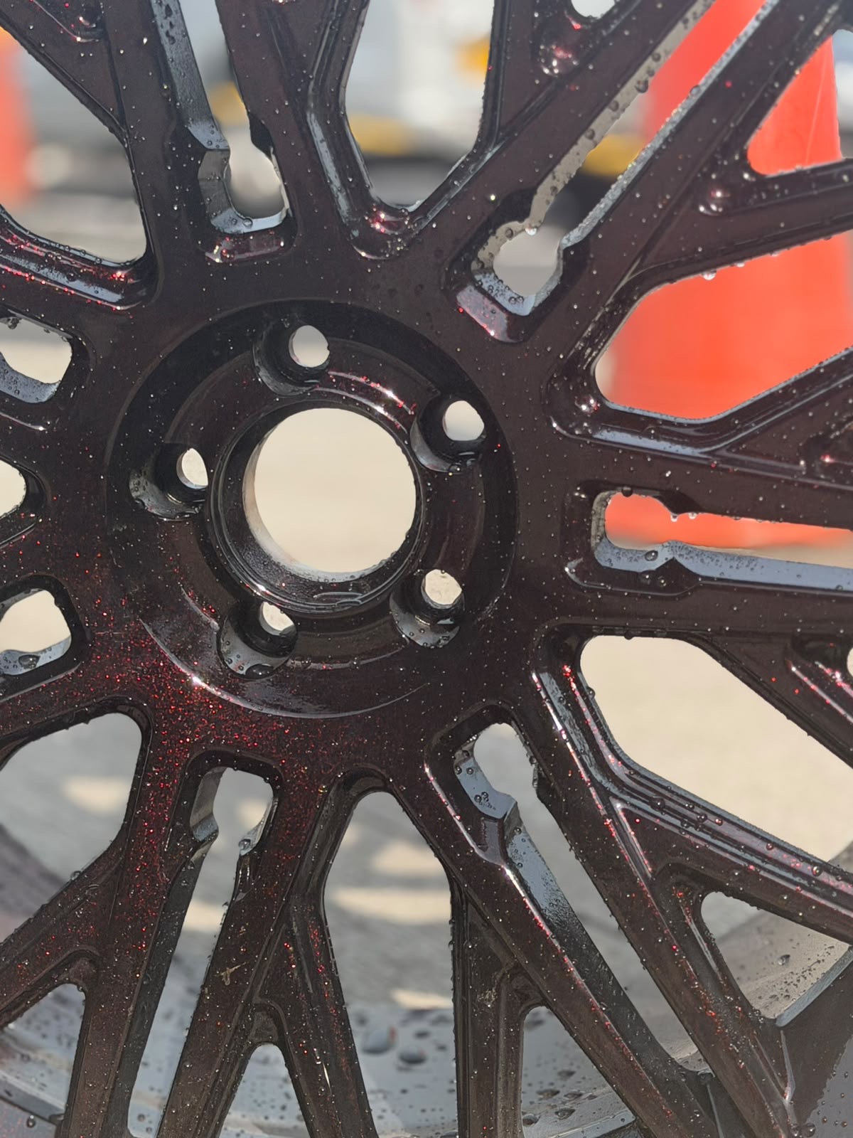 Custom candy red metallic-flake alloy wheel after refurbishment