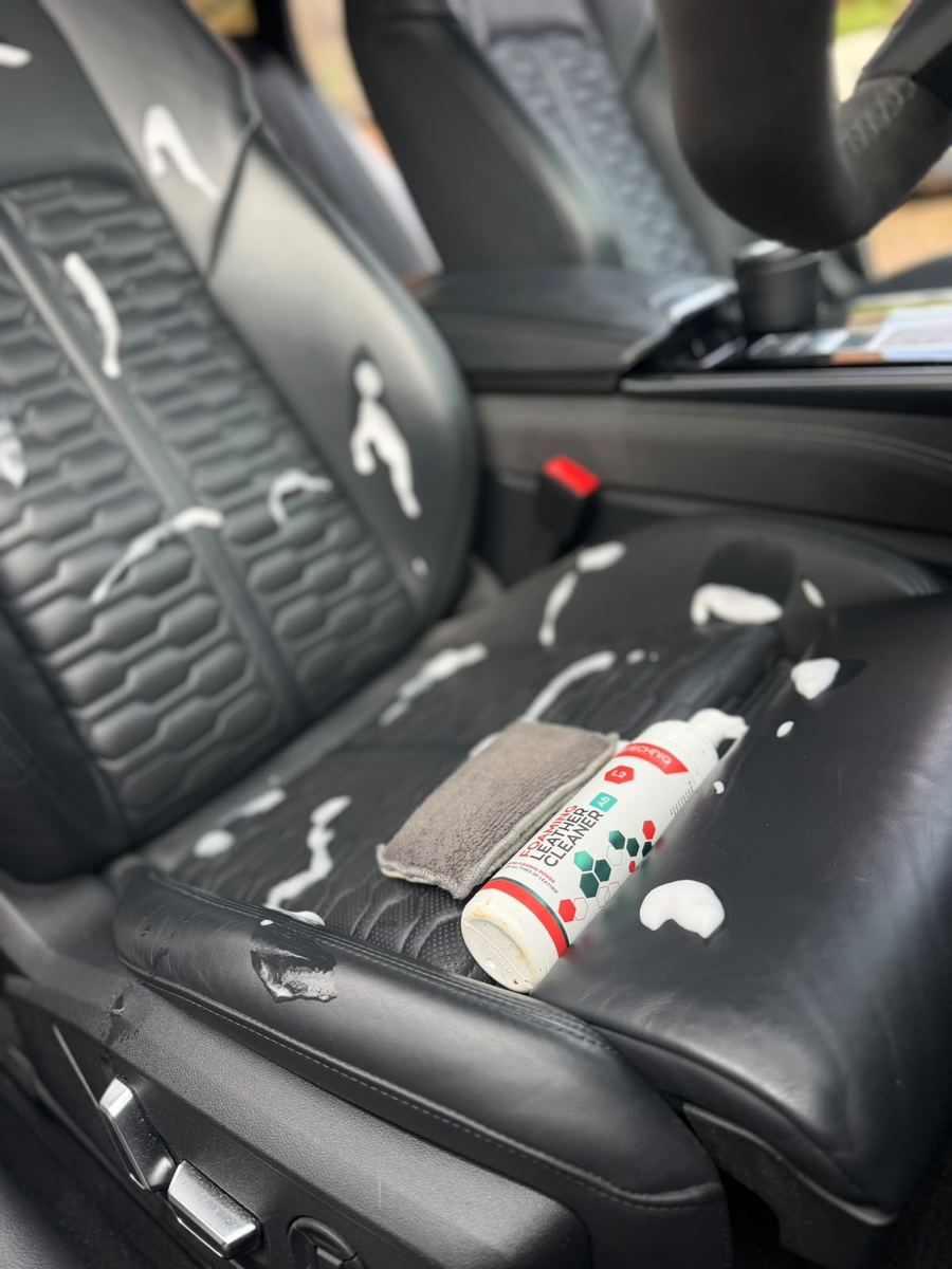 Foaming leather cleaner and microfibre on the Audi RS6 seat during an interior clean