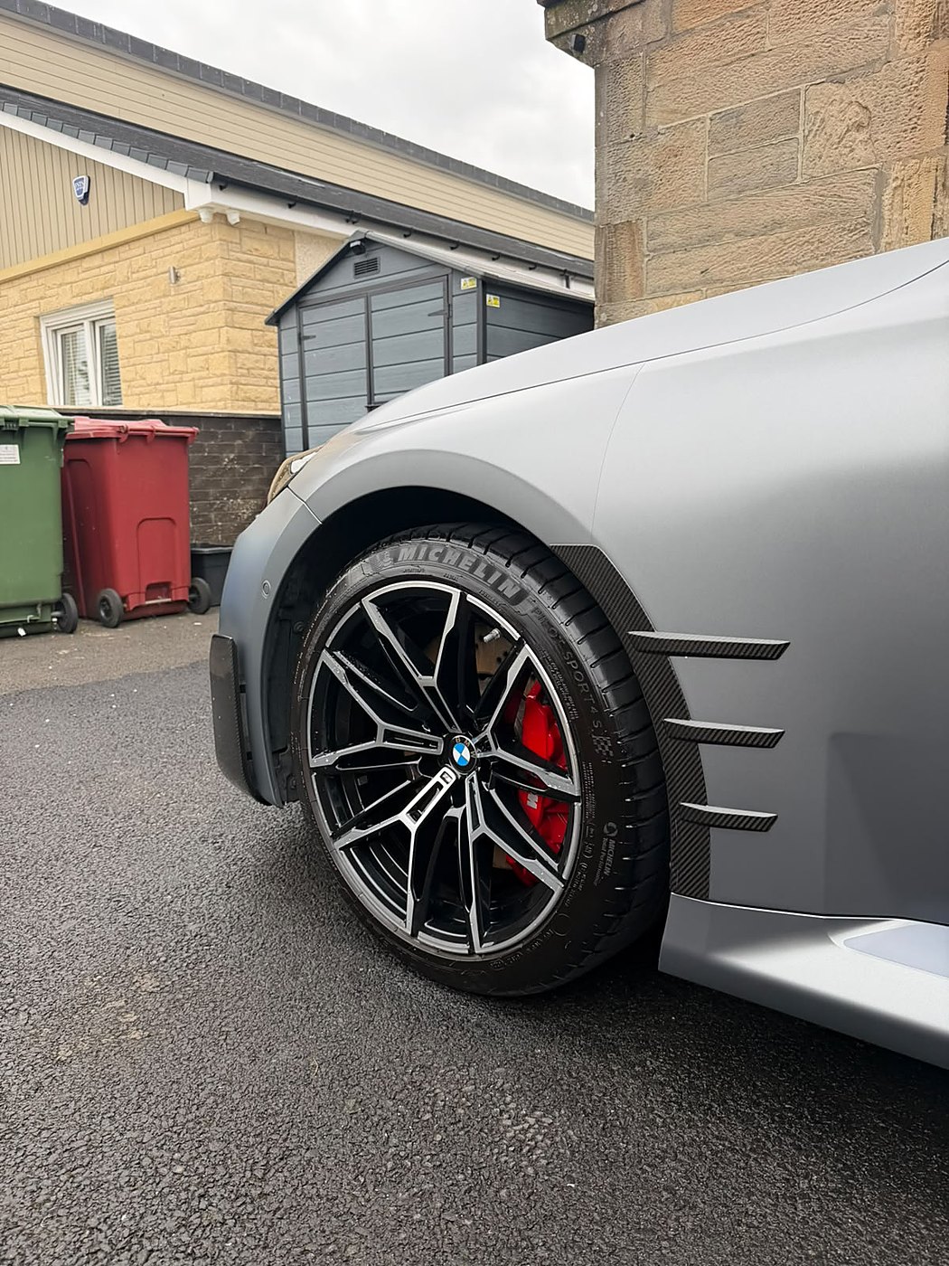 Silver performance car alloy wheel with a red brake caliper
