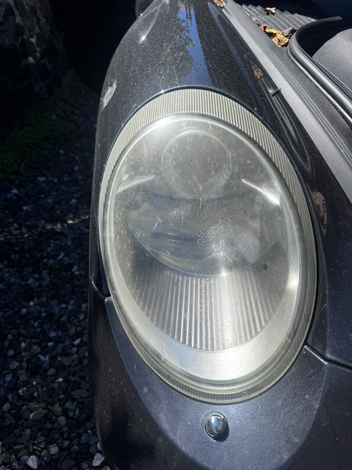 Close-up of hazed, oxidised headlight lens before restoration