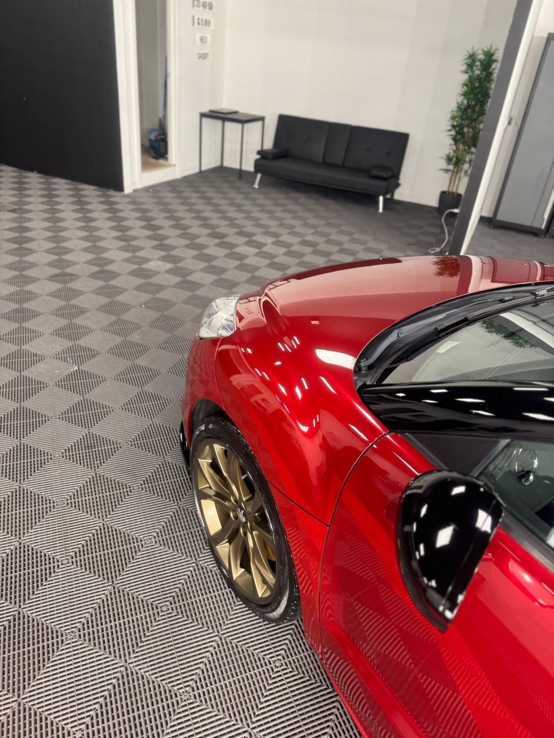 Red roadster after paint correction in the studio