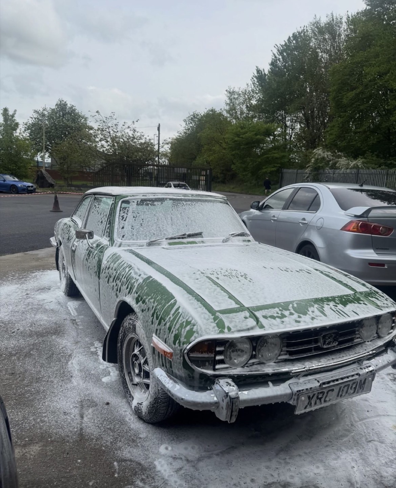 Classic Triumph Stag covered in snow foam during a safe wash