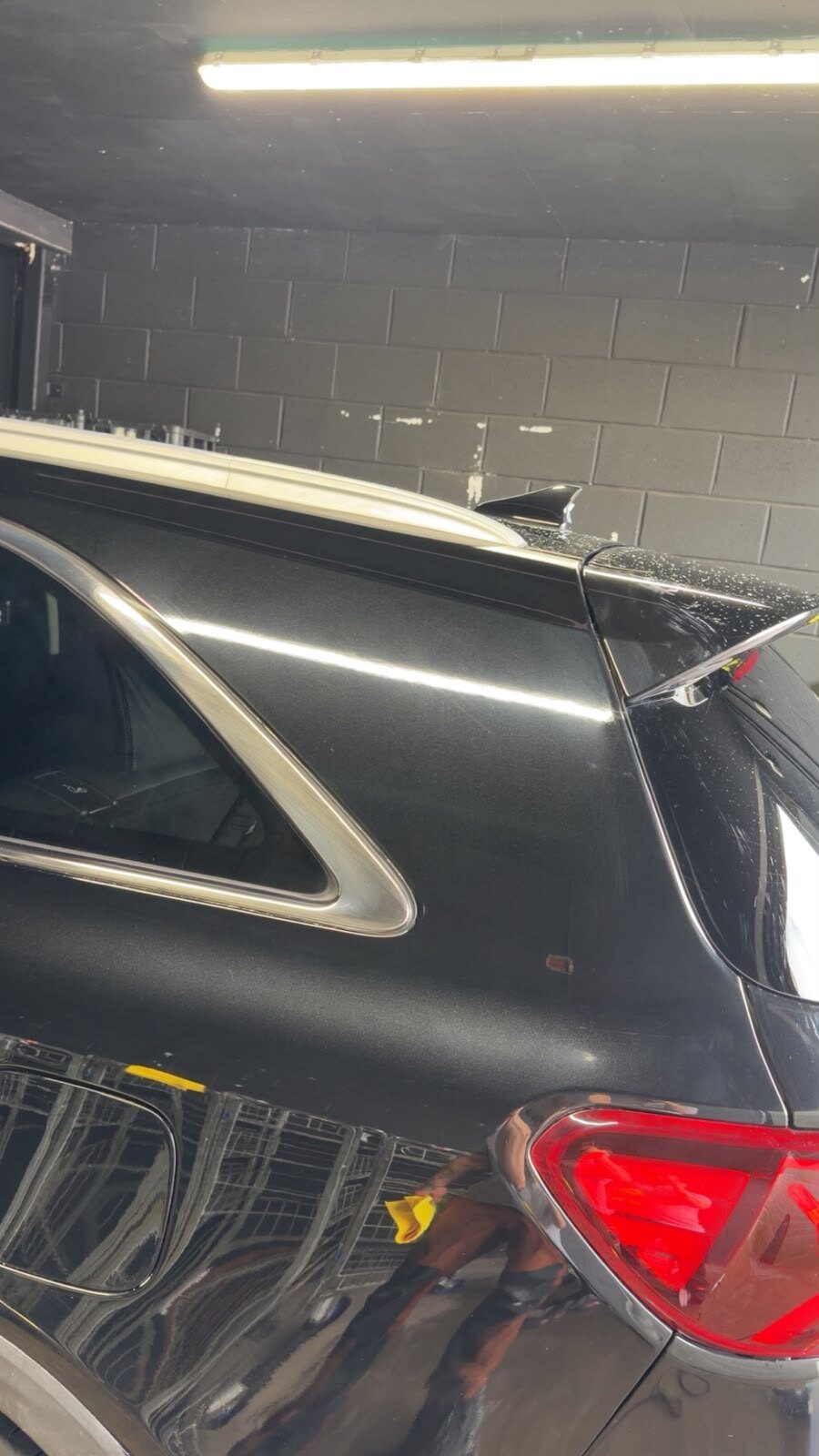 Black panel after wet sanding and machine polishing, back to a deep gloss