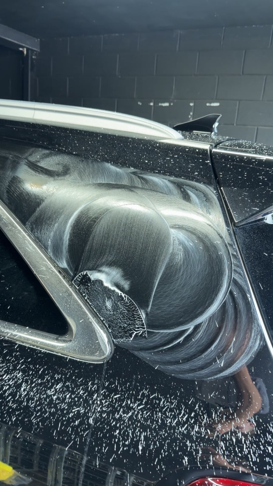 The same panel covered in white sanding slurry, with circular marks left by the sanding pad